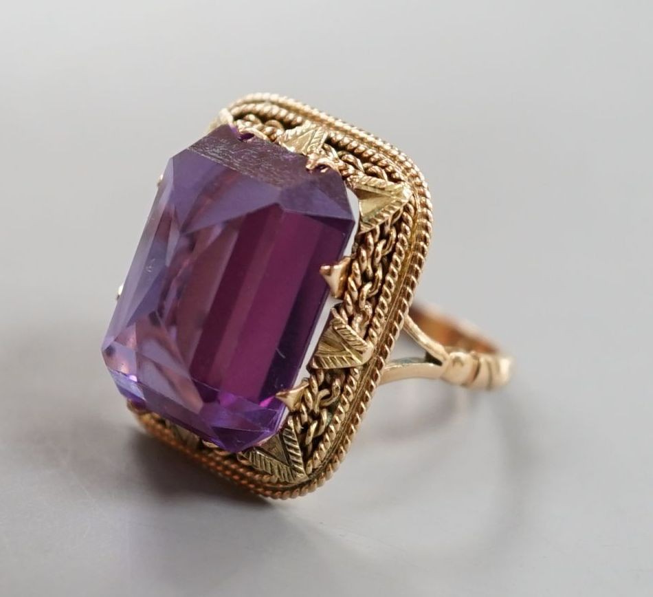 A 20th century Egyptian yellow metal and fancy cut synthetic colour change corundum set dress ring, size M/N, gross weight 9 grams.